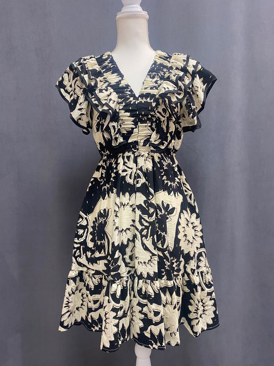 Bold print dress with layered ruffles / black and cream with metallic gold accents.